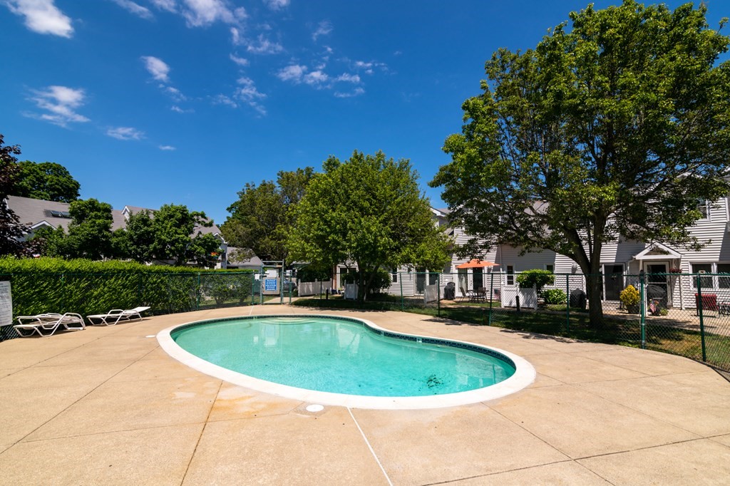26 School Street, Unit 211 Hull, MA 02045 - Photo 16 of 19 a view of a swimming pool and trees in the background