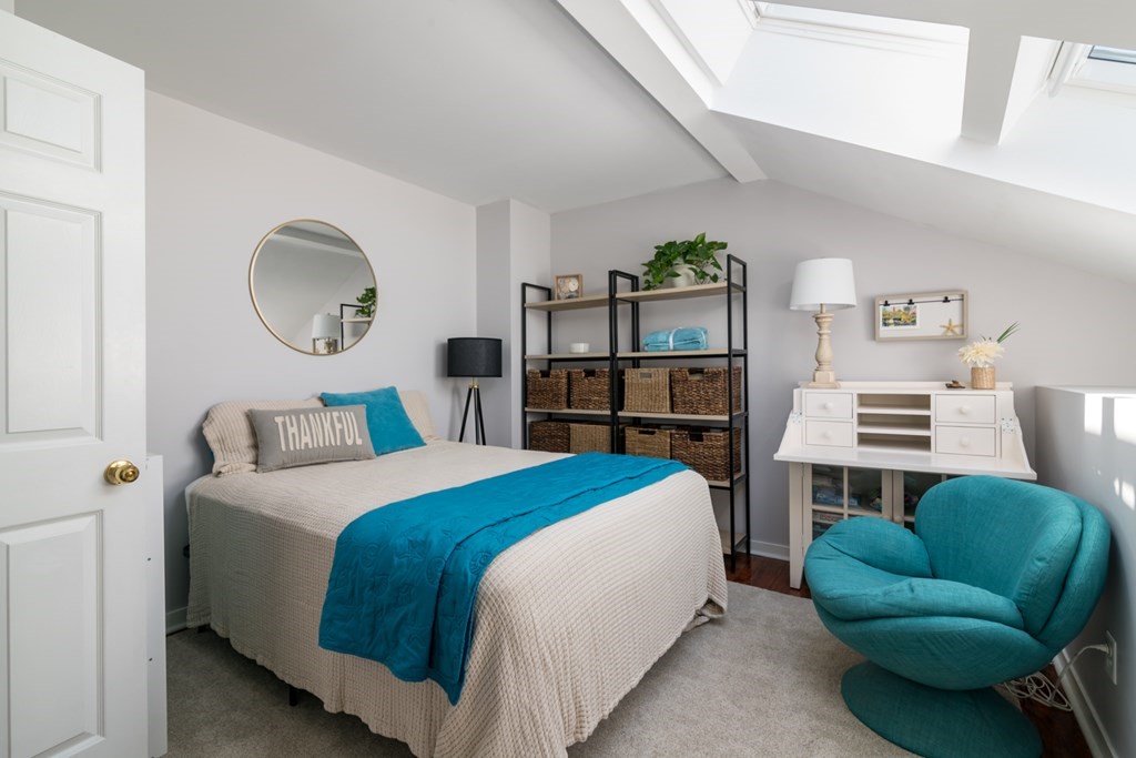 26 School Street, Unit 211 Hull, MA 02045 - Photo 4 of 19 a bed room with a bed and a chair