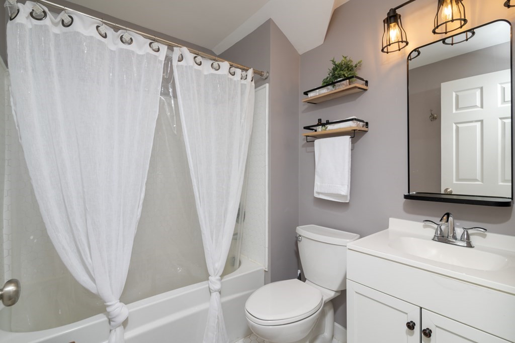 26 School Street, Unit 211 Hull, MA 02045 - Photo 5 of 19 a bathroom with a granite countertop sink toilet and shower