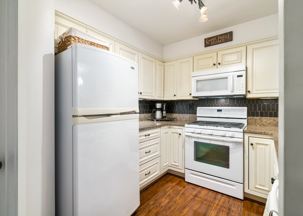 26 School Street, Unit 211 Hull, MA 02045 - Photo 7 of 19 a kitchen with white cabinets and white appliances