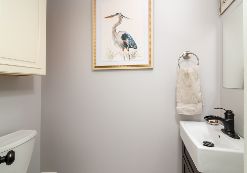 26 School Street, Unit 211 Hull, MA 02045 - Photo 9 of 19 a bathroom with a sink and mirror with toilet