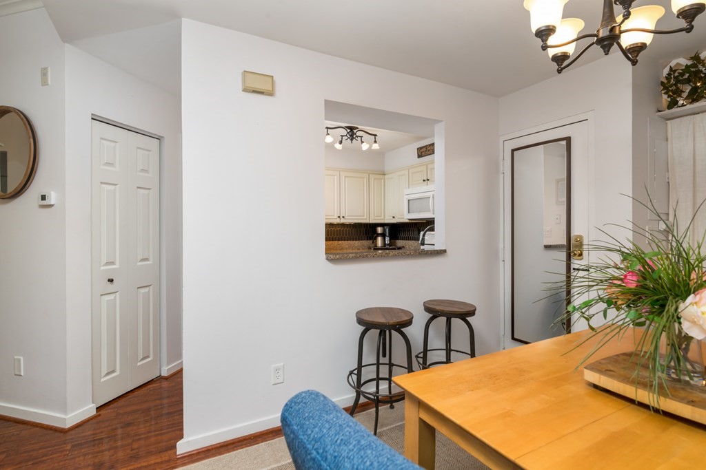 26 School Street, Unit 211 Hull, MA 02045 - Photo 10 of 19 a view of a workspace with furniture and wooden floor