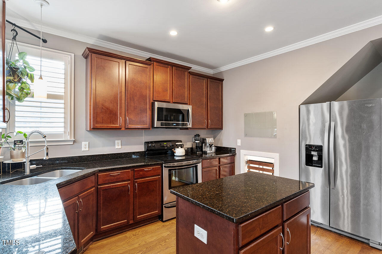 5 Spring Water Lane Durham, NC 27712 - Photo 12 of 32 a kitchen with stainless steel appliances granite countertop a stove a sink dishwasher a refrigerator and a microwave oven with wooden floor