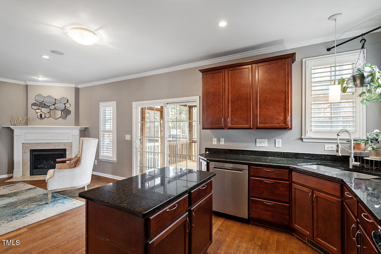5 Spring Water Lane Durham, NC 27712 - Photo 13 of 32 a kitchen with granite countertop a stove a sink and a microwave