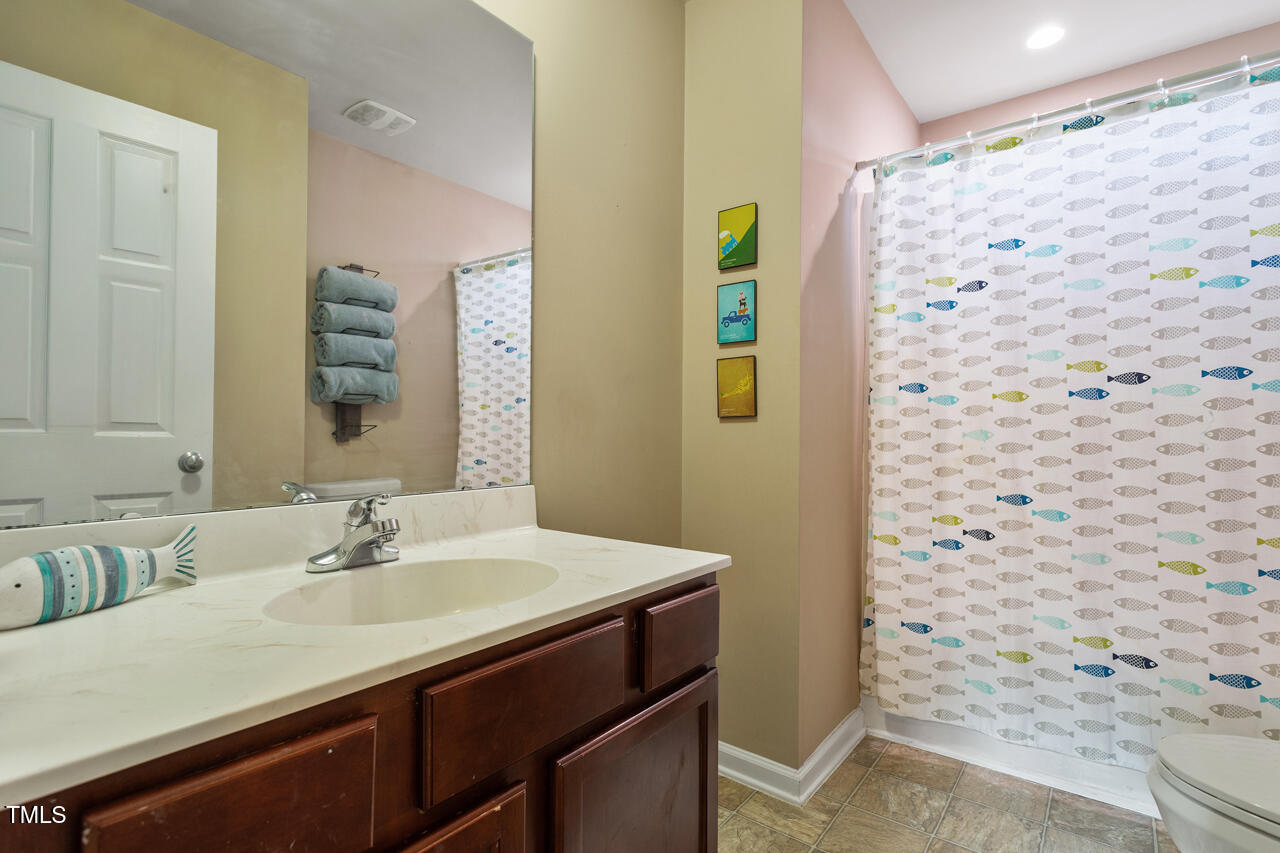 5 Spring Water Lane Durham, NC 27712 - Photo 17 of 32 a bathroom with a sink and a mirror