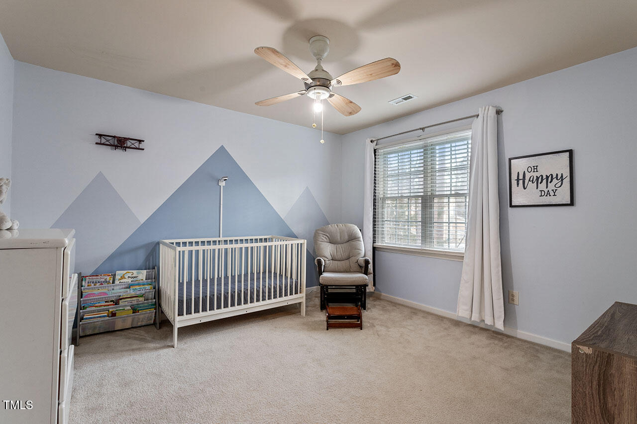 5 Spring Water Lane Durham, NC 27712 - Photo 23 of 32 a living room with a baby crib furniture and a window