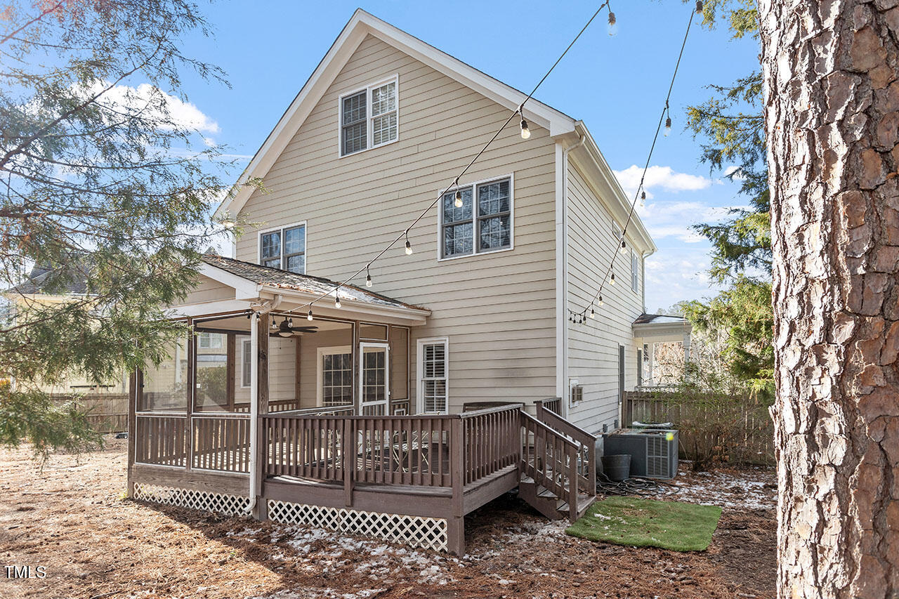 5 Spring Water Lane Durham, NC 27712 - Photo 29 of 32 a view of a white house with a large window and outdoor space