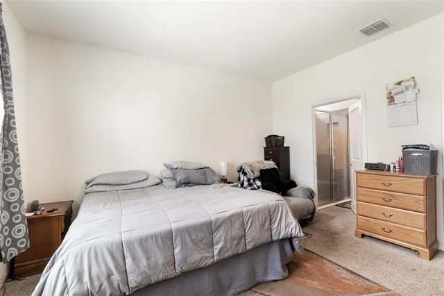 a bedroom with a bed and dresser