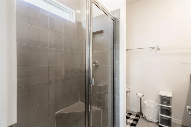 a bathroom with a glass shower door
