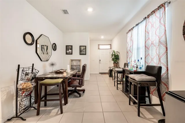 a view of a dining room with furniture and a large window