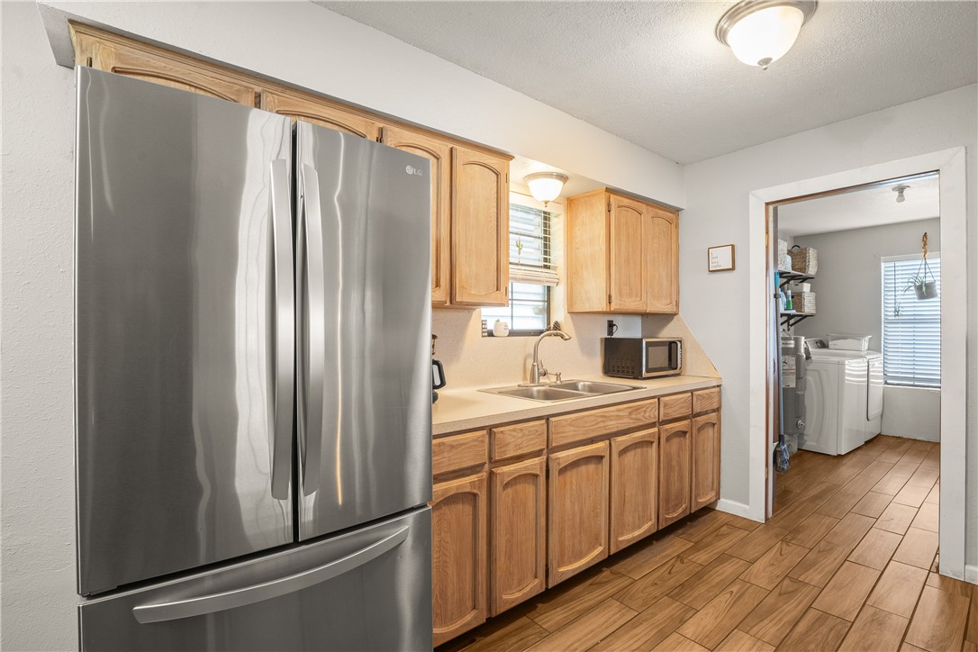 167 Trail Ridge Drive Sandia, TX 78383 - Photo 11 of 33 a kitchen with stainless steel appliances a sink cabinets and wooden floor