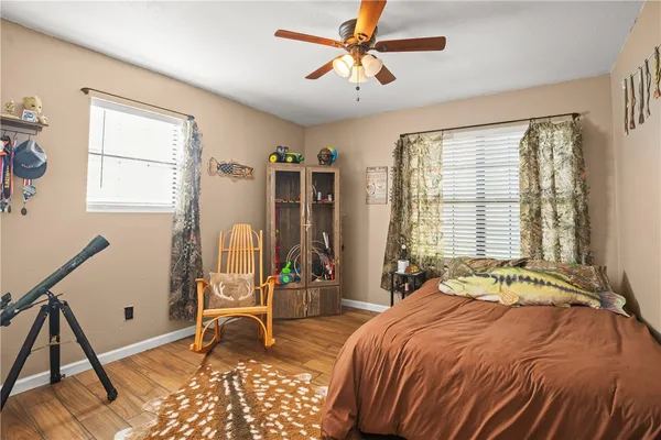 a bed sitting in a bedroom next to a window