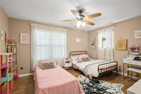 a bedroom with two beds and a window