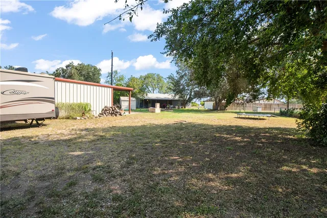 a view of a yard with swimming pool and sitting area