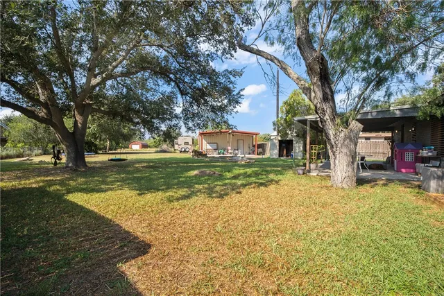 a view of a tree in front of a house