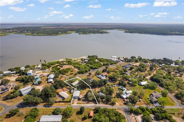 an aerial view of a residential houses with lake view