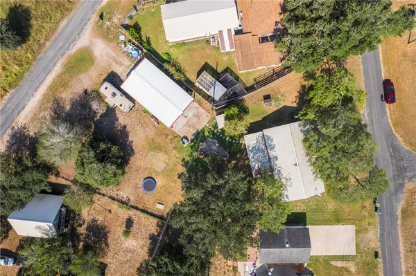 an aerial view of a house with a yard and garden
