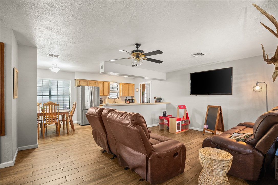 167 Trail Ridge Drive Sandia, TX 78383 - Photo 6 of 33 a living room with furniture fireplace and a flat screen tv