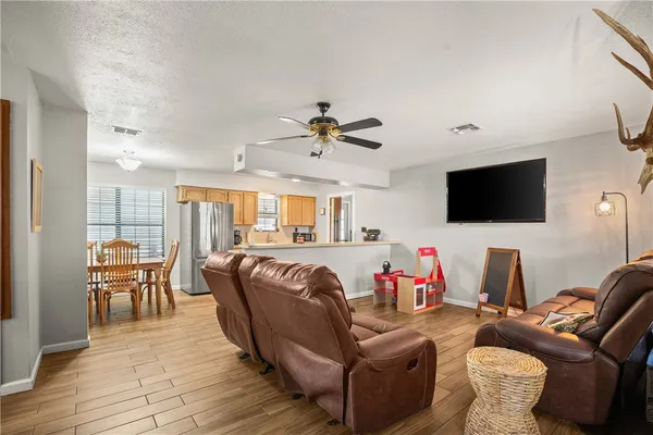 a living room with furniture fireplace and a flat screen tv