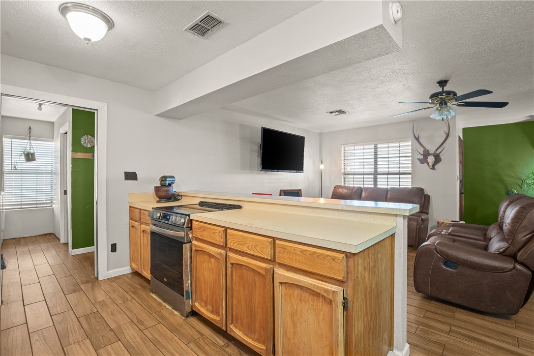 167 Trail Ridge Drive Sandia, TX 78383 - Photo 10 of 33 a kitchen with stainless steel appliances granite countertop a sink stove and refrigerator