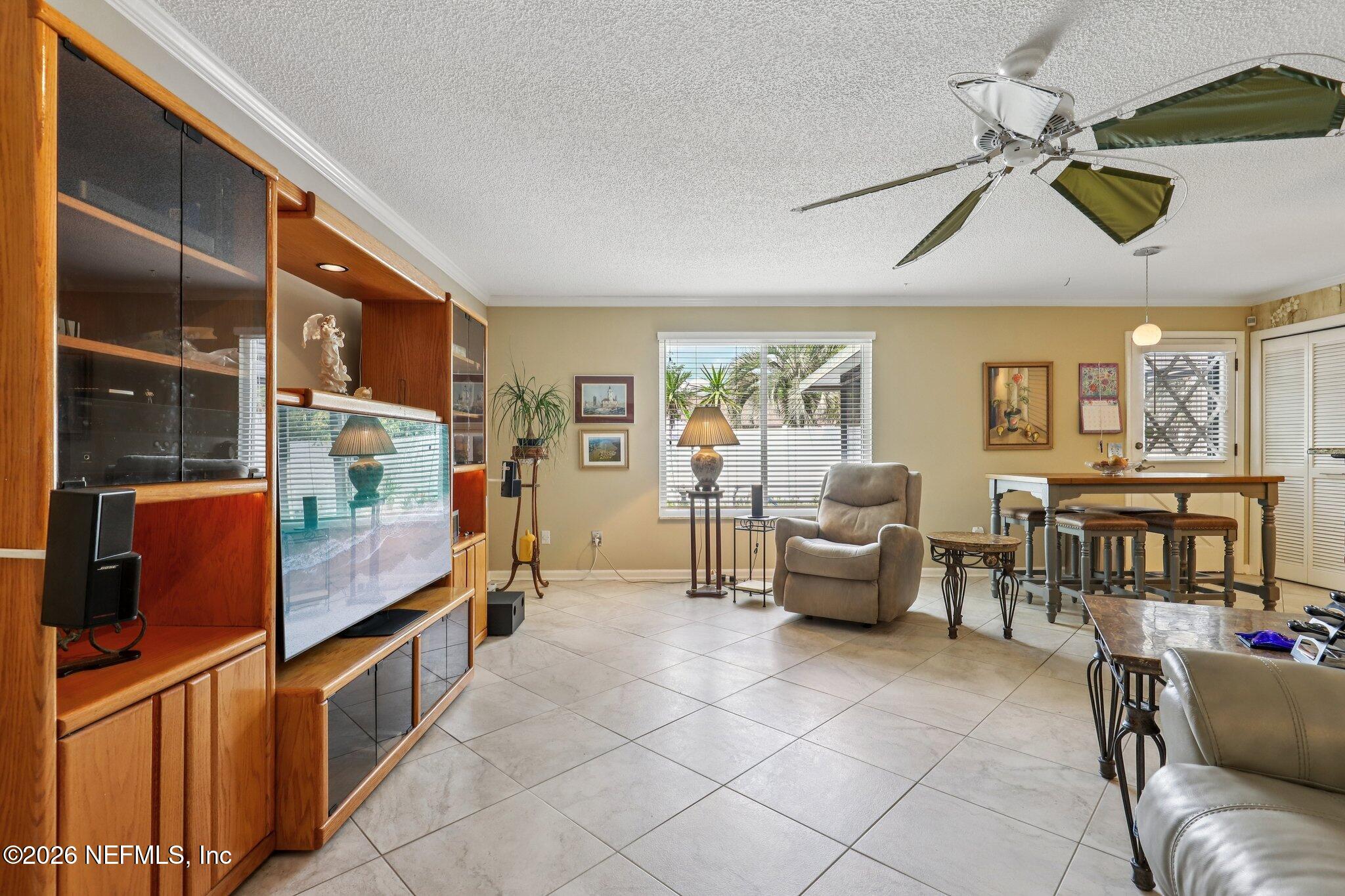 11654 Lake Ride Drive Jacksonville, FL 32223 - Photo 11 of 36 a living room with furniture and a floor to ceiling window