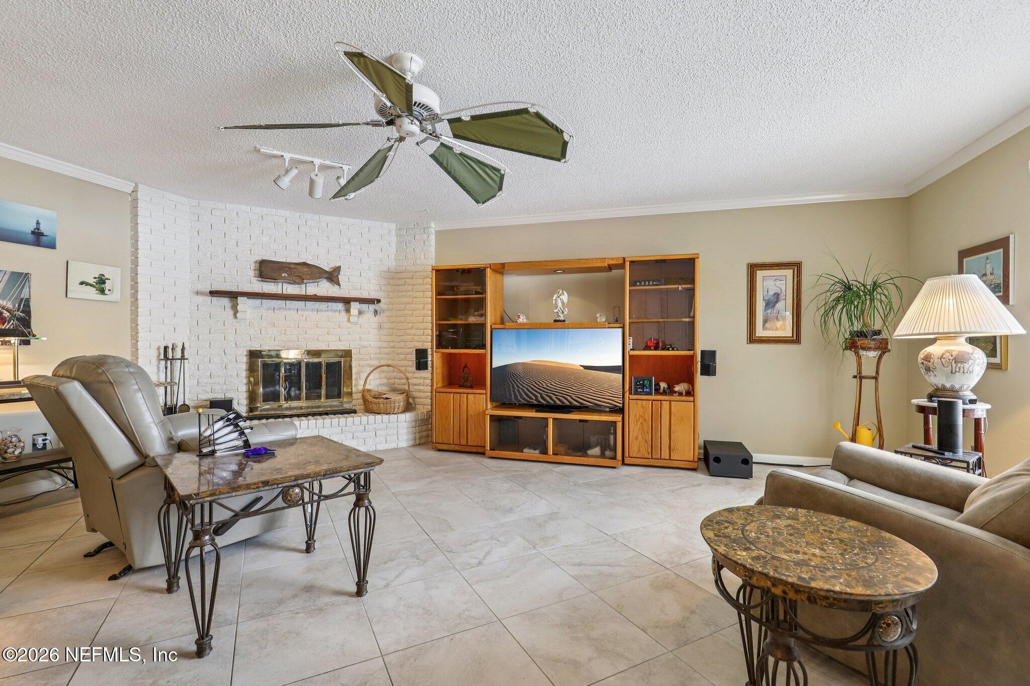 11654 Lake Ride Drive Jacksonville, FL 32223 - Photo 12 of 36 a living room with furniture and a fireplace
