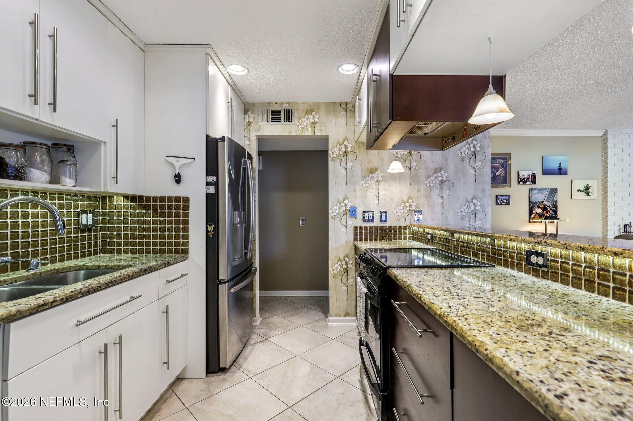 11654 Lake Ride Drive Jacksonville, FL 32223 - Photo 13 of 36 a kitchen with counter top space cabinets and stainless steel appliances