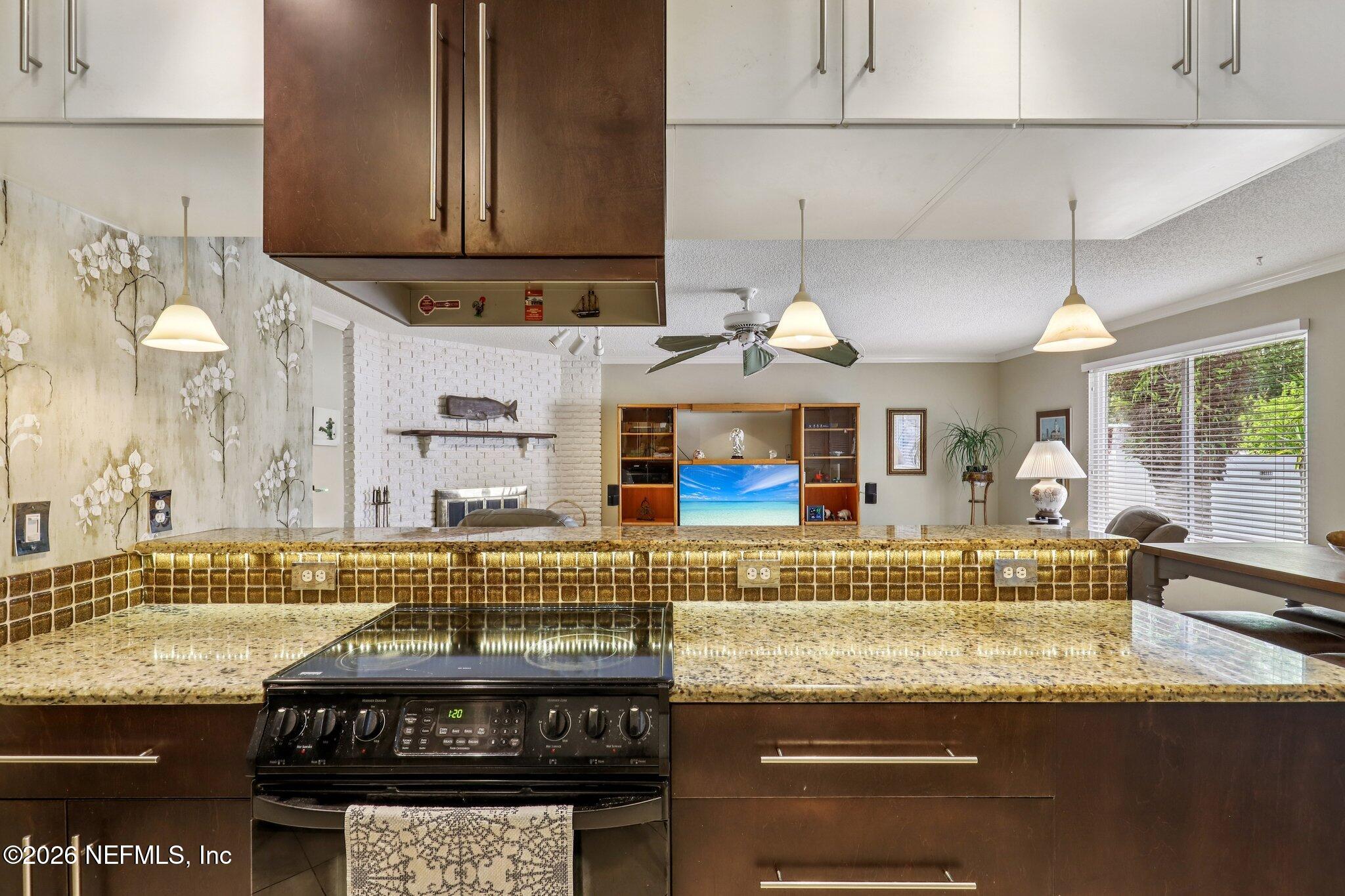 11654 Lake Ride Drive Jacksonville, FL 32223 - Photo 16 of 36 a kitchen with a stove and a cabinets