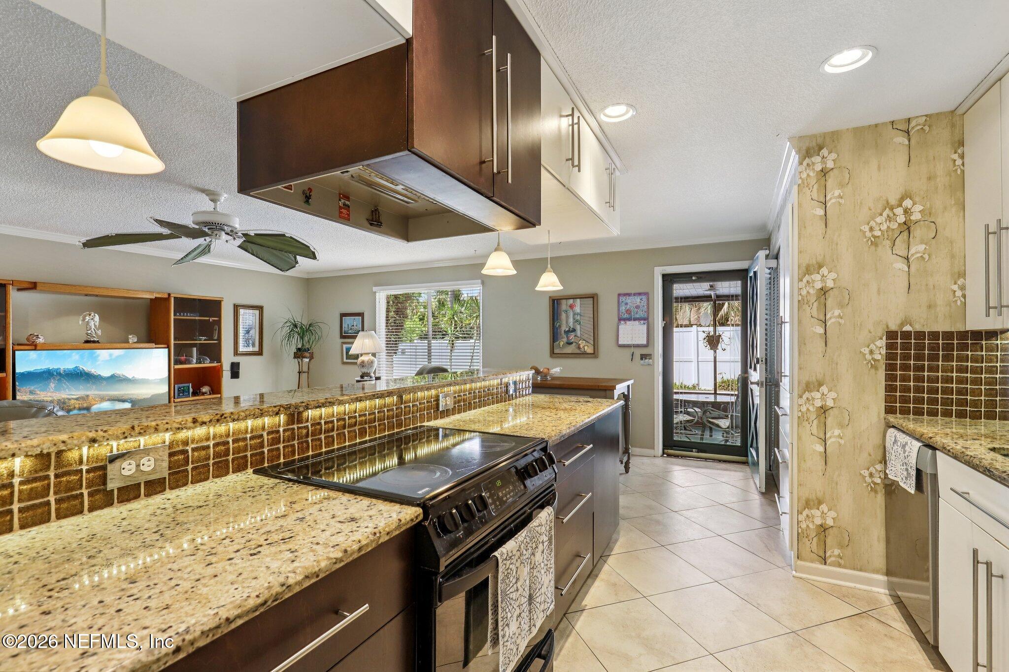 11654 Lake Ride Drive Jacksonville, FL 32223 - Photo 18 of 36 a kitchen with stainless steel appliances granite countertop a sink and cabinets