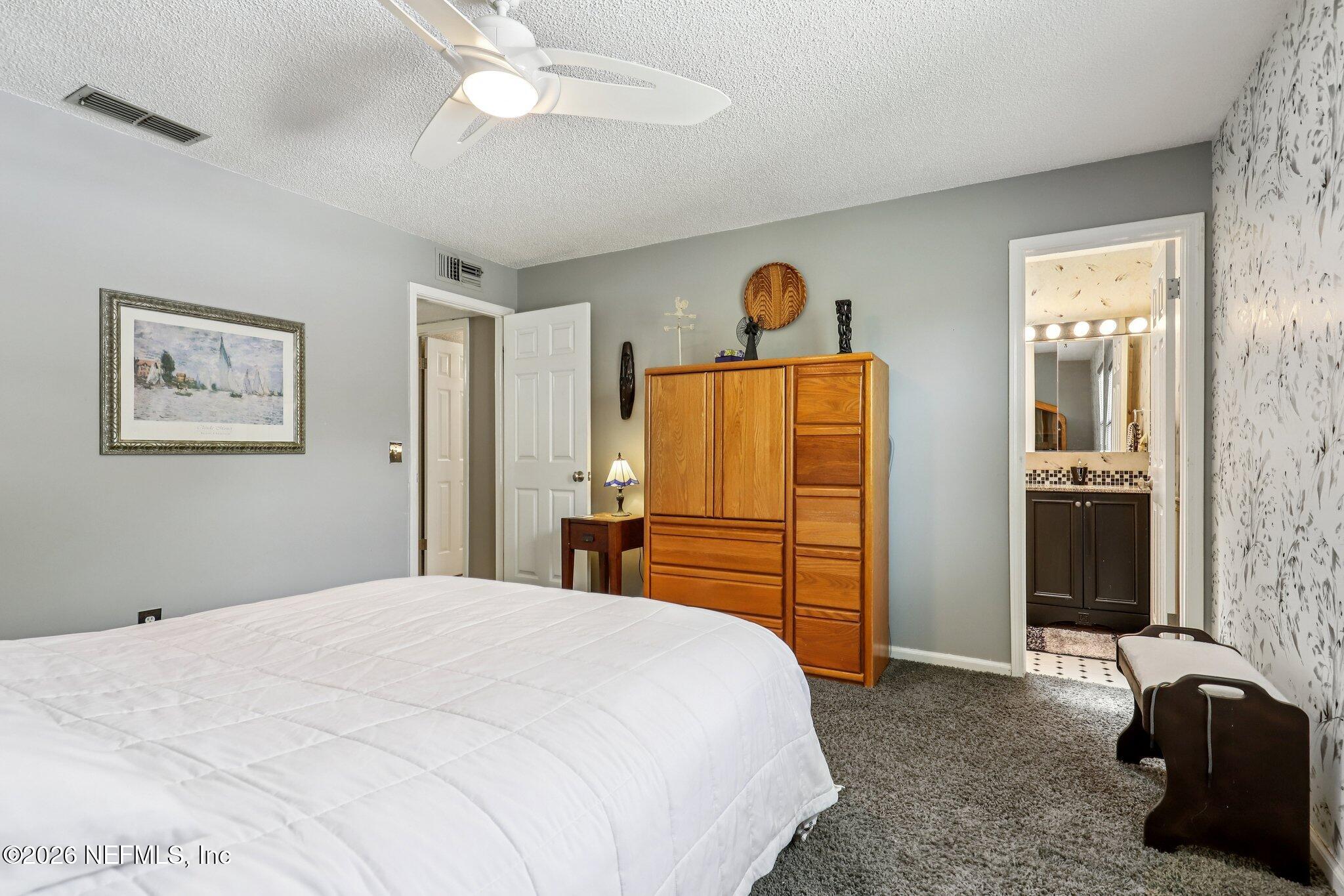 11654 Lake Ride Drive Jacksonville, FL 32223 - Photo 21 of 36 a bedroom with a bed and a refrigerator