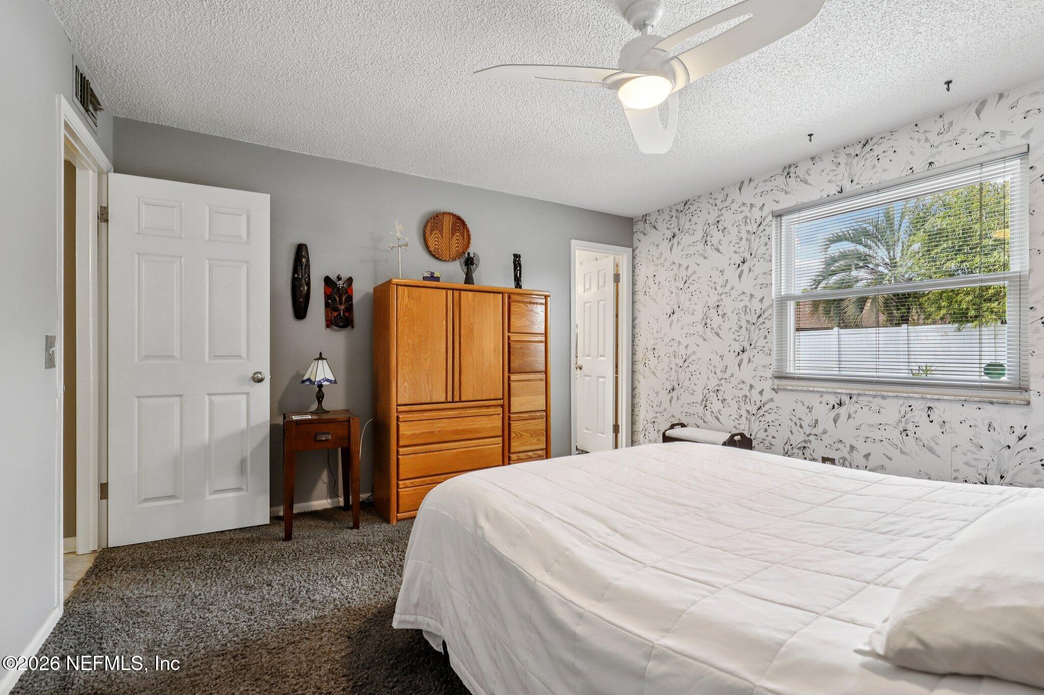 11654 Lake Ride Drive Jacksonville, FL 32223 - Photo 22 of 36 a bedroom with a bed and a large mirror