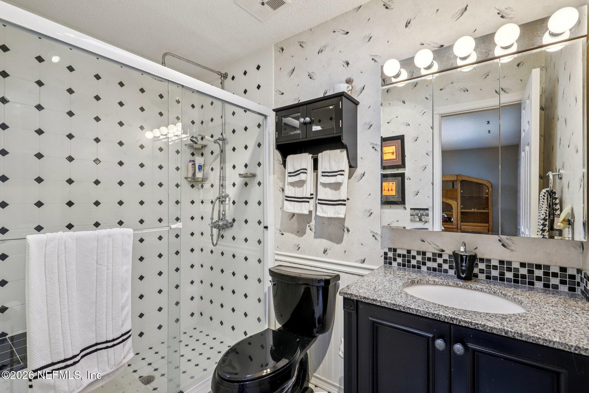 11654 Lake Ride Drive Jacksonville, FL 32223 - Photo 23 of 36 a bathroom with a sink toilet and shower