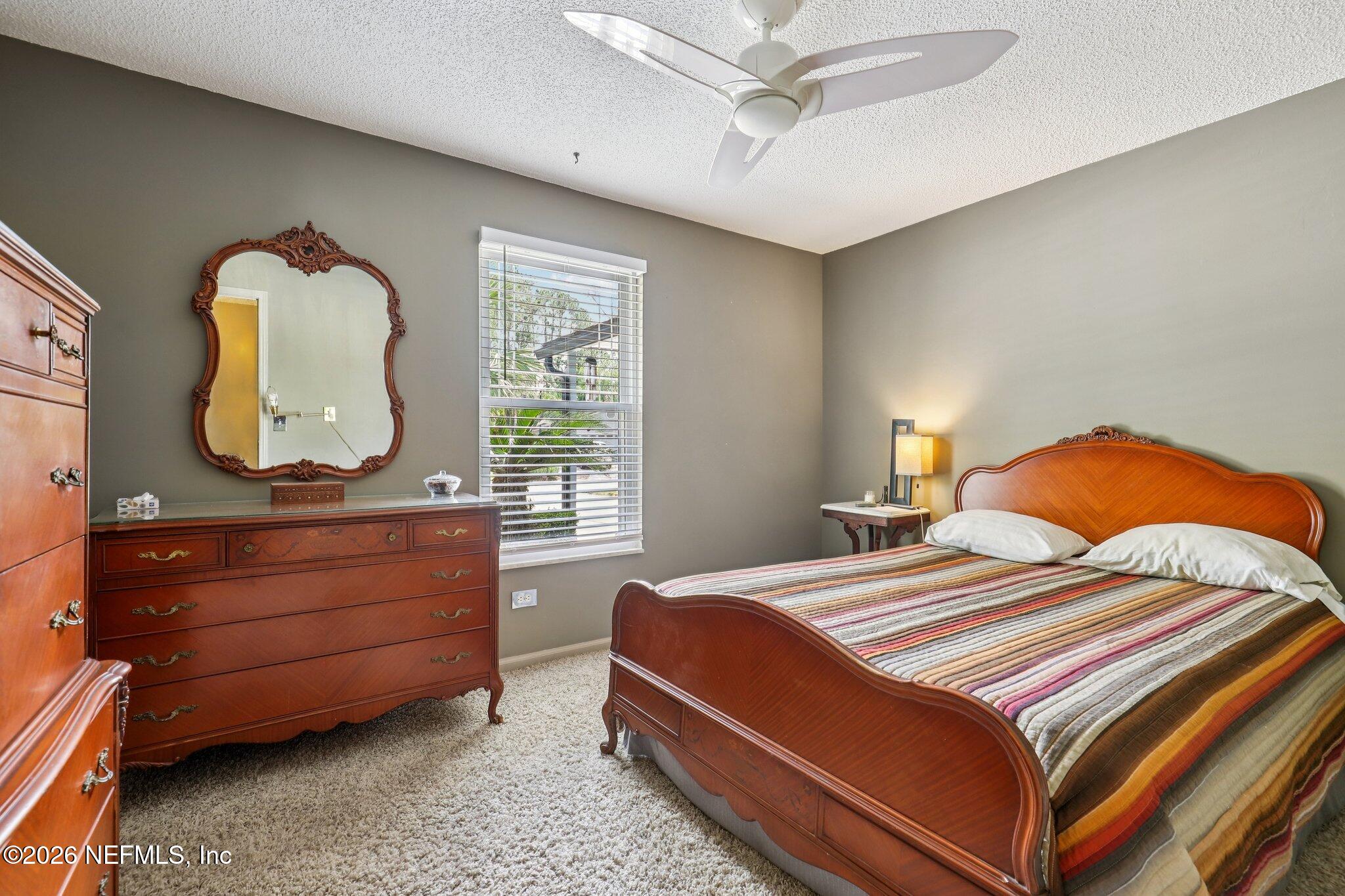 11654 Lake Ride Drive Jacksonville, FL 32223 - Photo 24 of 36 a bedroom with a bed and window