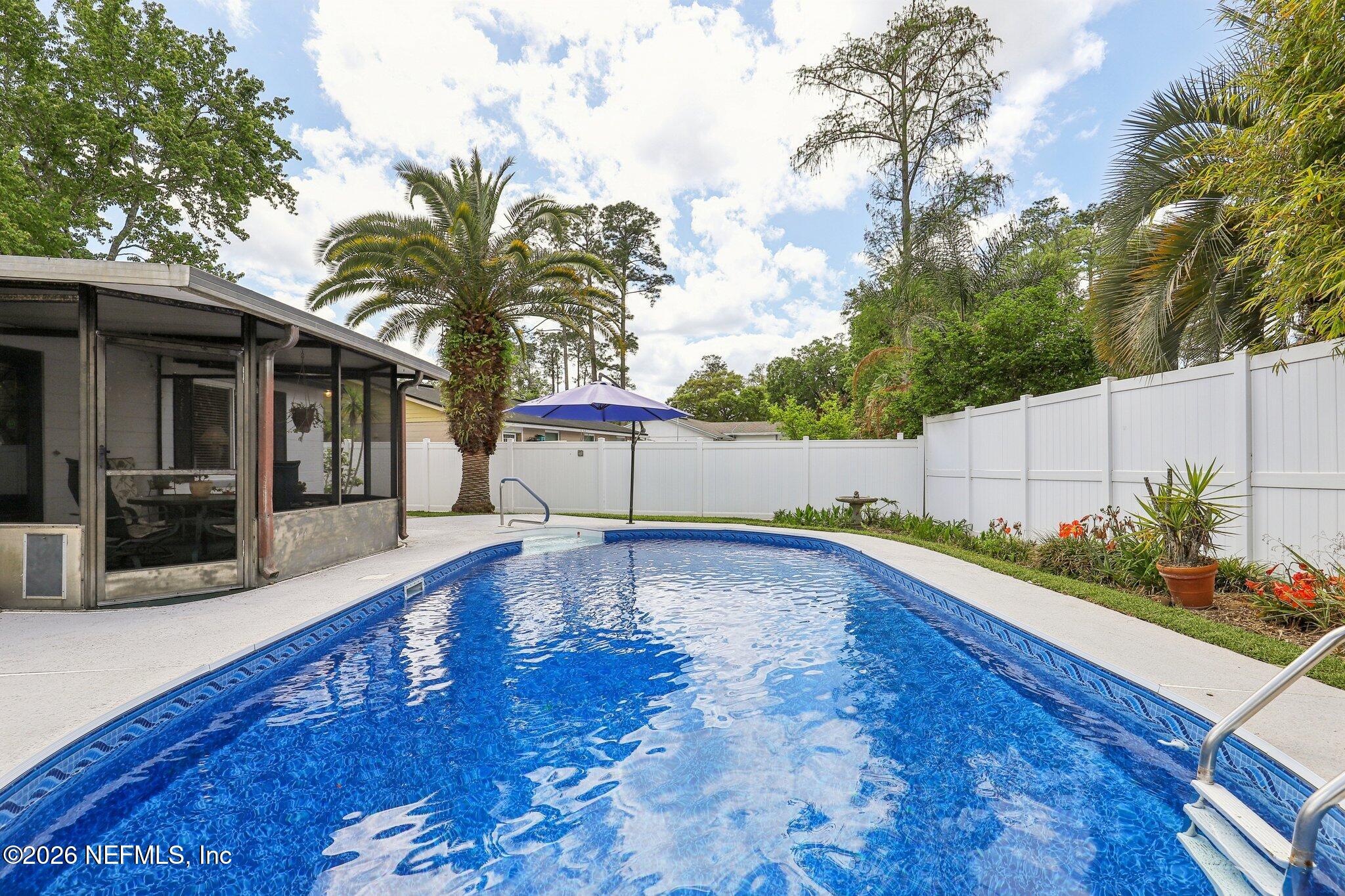 11654 Lake Ride Drive Jacksonville, FL 32223 - Photo 31 of 36 a view of a room with wooden floor and potted plants