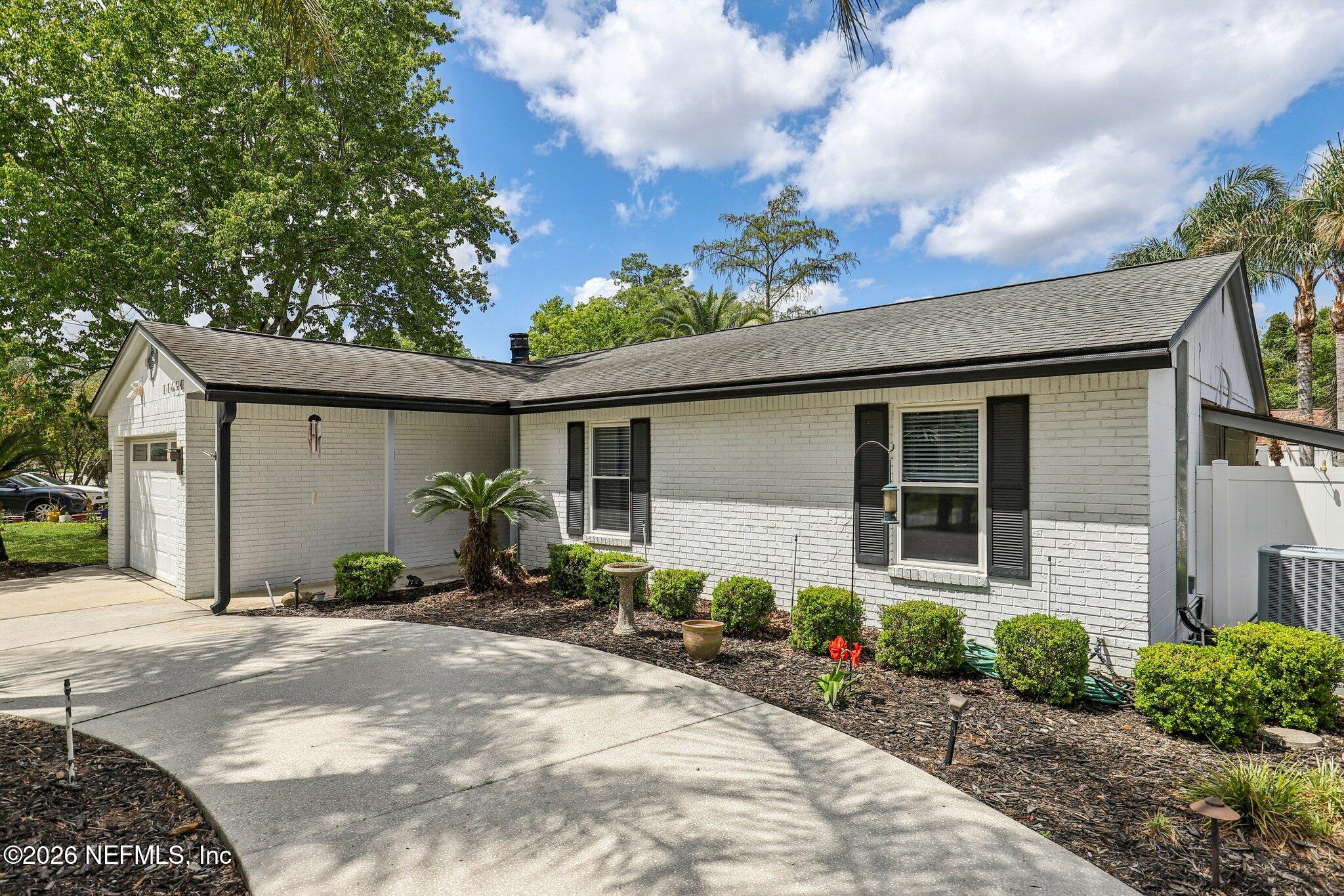 11654 Lake Ride Drive Jacksonville, FL 32223 - Photo 5 of 36 a front view of a house with garden