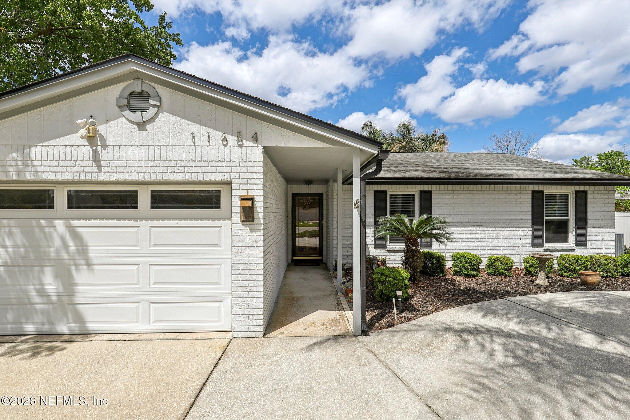 11654 Lake Ride Drive Jacksonville, FL 32223 - Photo 6 of 36 a front view of a house with garden