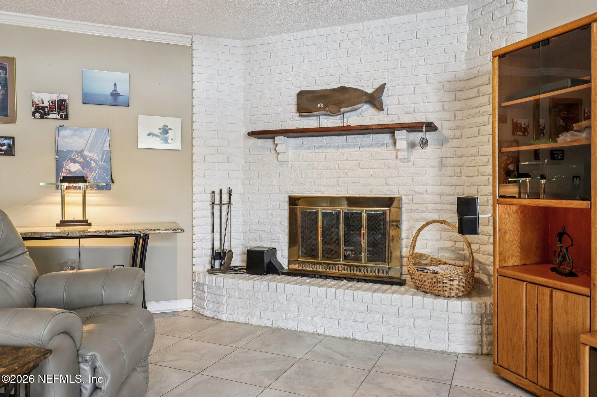 11654 Lake Ride Drive Jacksonville, FL 32223 - Photo 10 of 36 a living room with furniture and a fireplace
