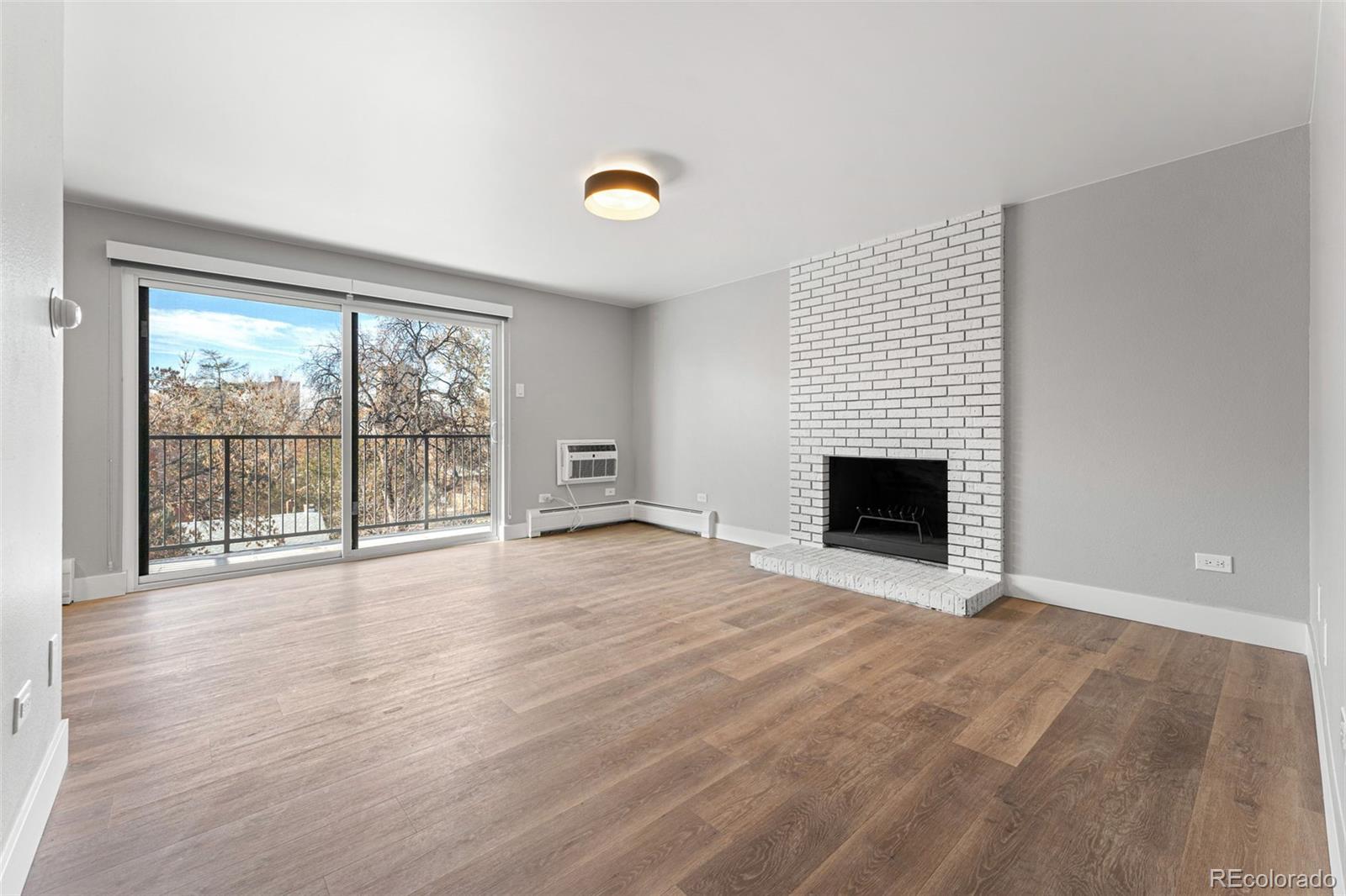 wooden floor fireplace and natural light in room