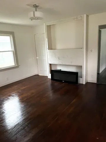 a view of an empty room and wooden floor