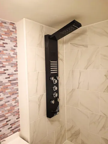 a bathroom with a shower and a shower curtain