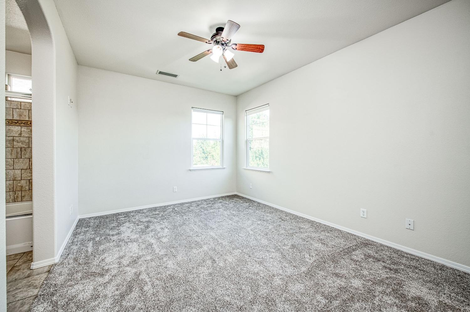 3991 Harlan Ranch Boulevard Clovis, CA 93619 - Photo 12 of 21 an empty room with windows and fan