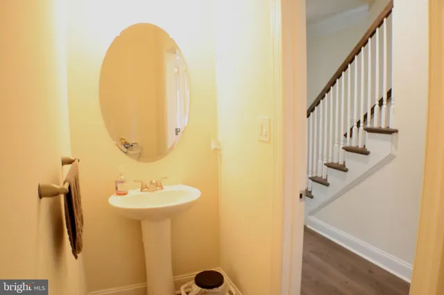 a bathroom with a sink mirror and toilet