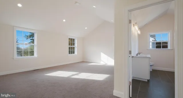 an empty room with windows and closet