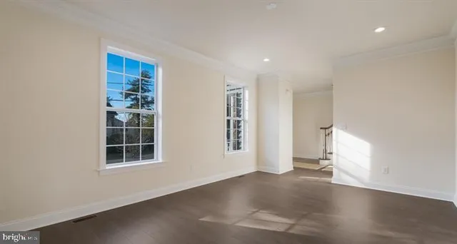 an empty room with a fireplace and window