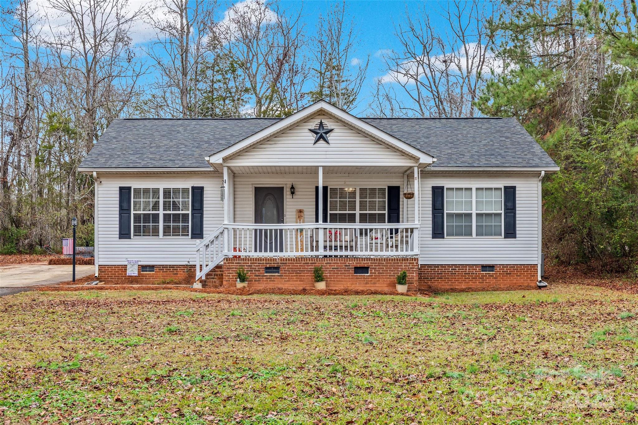 332 Sutton Spring Road York, SC 29745 - Photo 1 of 21 a house view with a sitting space garden view with large tree