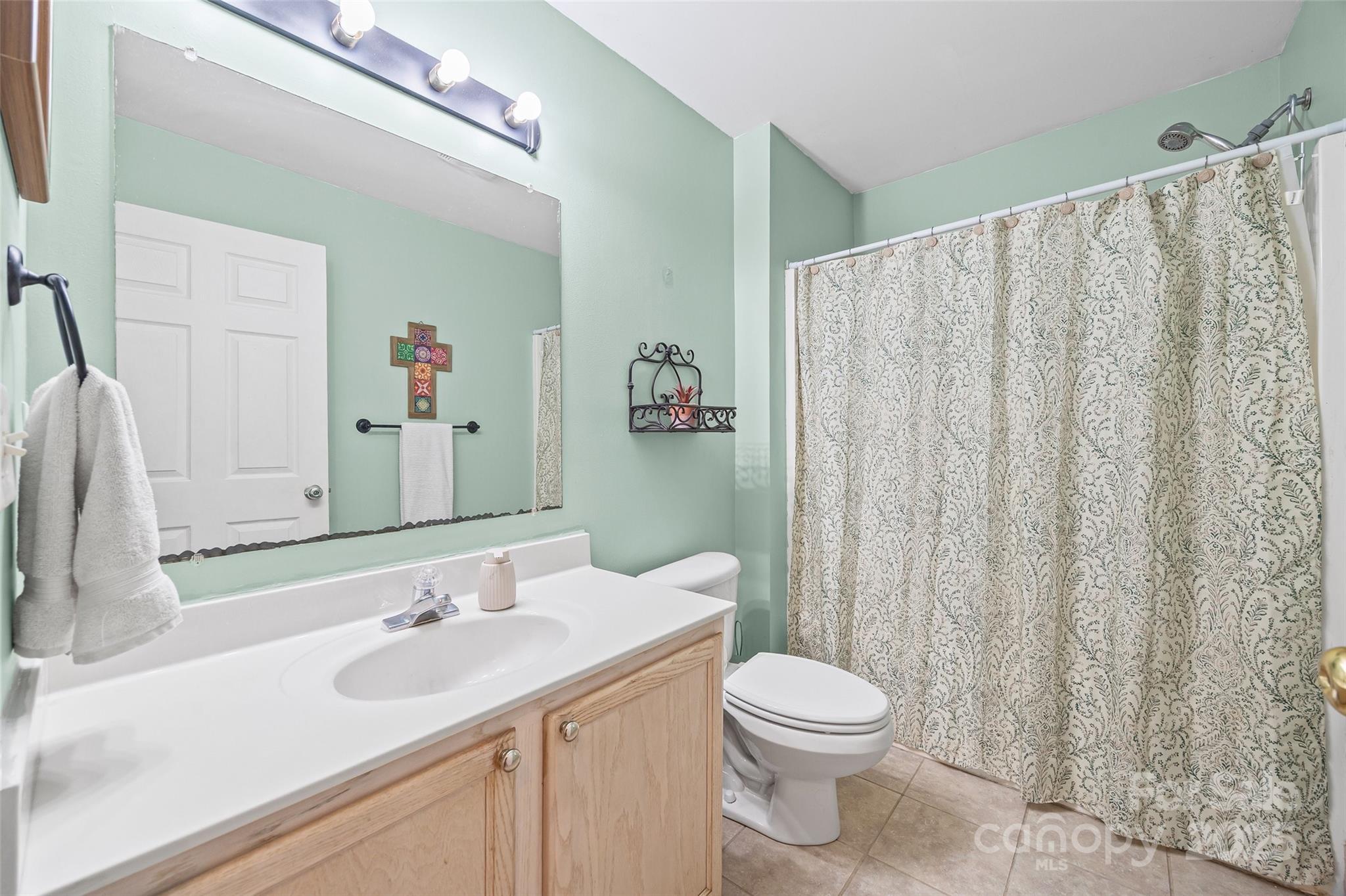 332 Sutton Spring Road York, SC 29745 - Photo 15 of 21 a bathroom with a toilet a sink and curtain