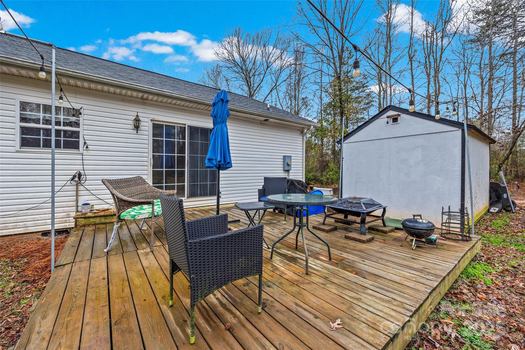 332 Sutton Spring Road York, SC 29745 - Photo 19 of 21 a view of a roof deck with table and chairs wooden floor and fence