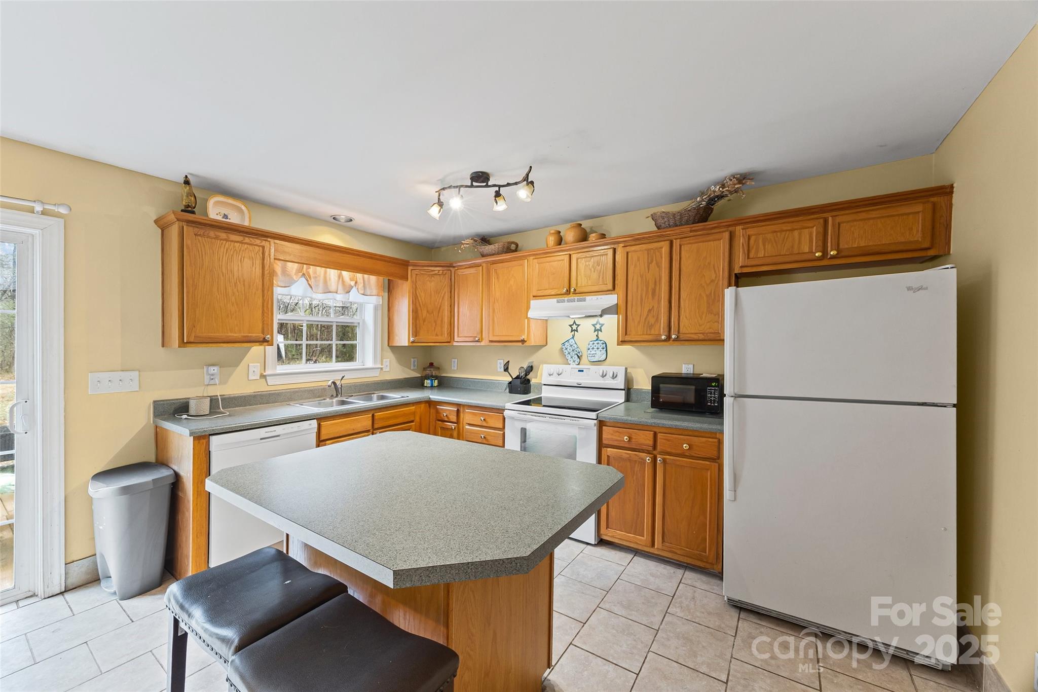 332 Sutton Spring Road York, SC 29745 - Photo 6 of 21 a kitchen with a refrigerator a stove top oven a sink dishwasher and white cabinets with wooden floor