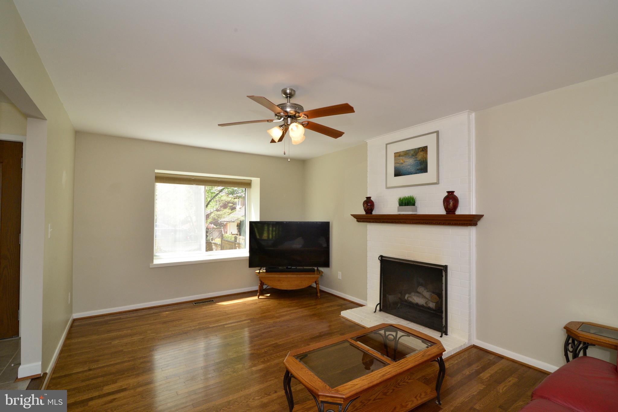 11086 Glade Court Reston, VA 20191 - Photo 10 of 44 The living room also has a wood-burning fireplace.