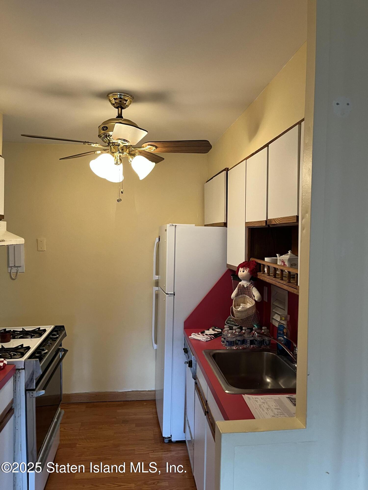 1000 Clove Road, Unit 4P Staten Island, NY 10301 - Photo 12 of 25 a kitchen with stainless steel appliances granite countertop a stove and a refrigerator